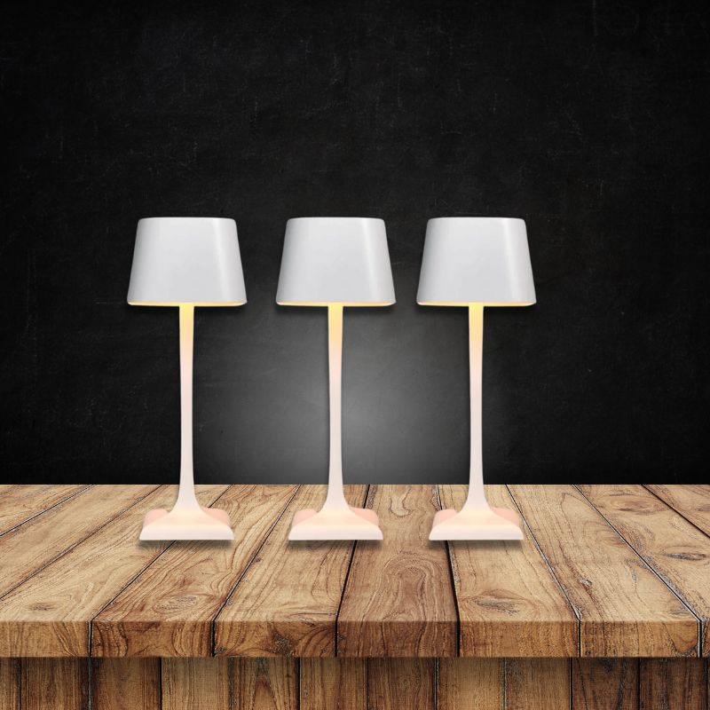 Cordless table lamp with touch controls on a bedside table, portable for any room