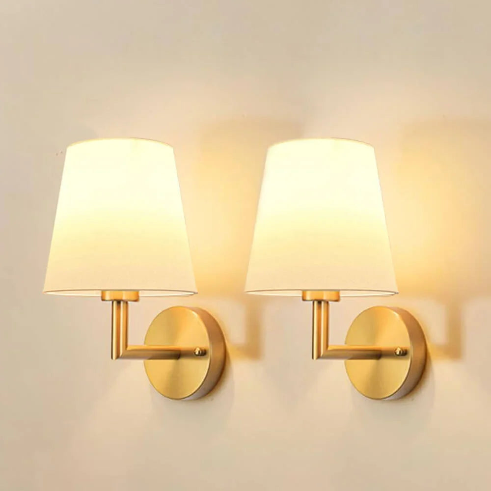 Wireless fabric wall sconce with metal accents, mounted on a wall, for renters