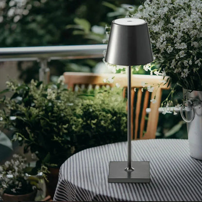 Cordless waterproof table lamp on an outdoor dining table for patio use