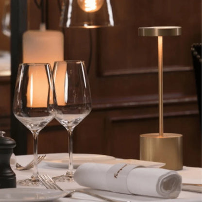 Cordless table lamp with warm light on an outdoor dining table