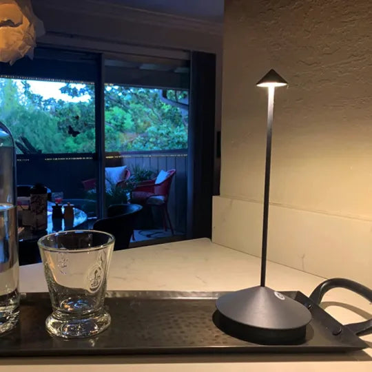 Cordless LED table lamp on a patio table for outdoor ambiance