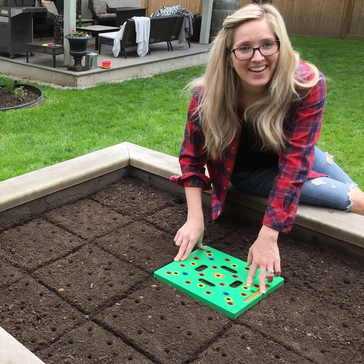 Square foot garden seed spacing template on a raised bed for beginners