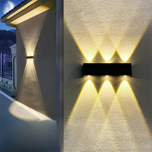 Black aluminum solar up down wall light mounted on exterior wall, no wires visible