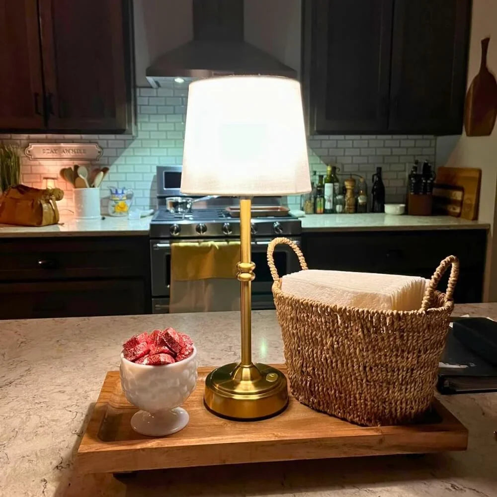 Cordless LED table lamp with fabric shade on a shelf in an apartment