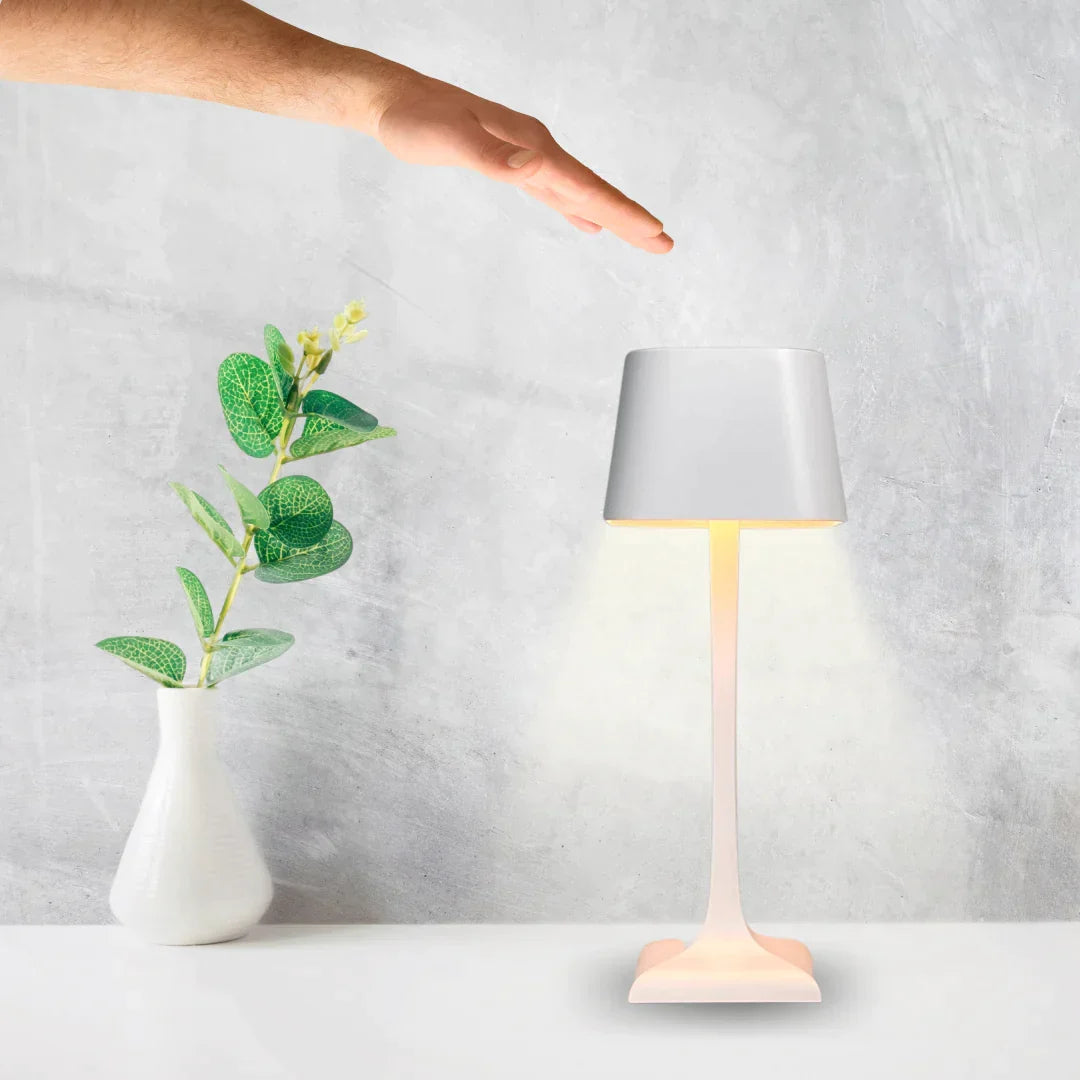 Cordless table lamp with touch controls on a bedside table, portable for any room