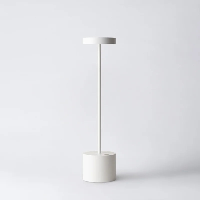 Cordless table lamp with warm light on an outdoor dining table