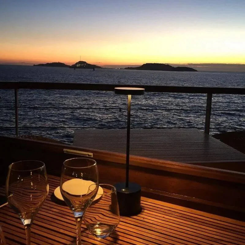 Cordless table lamp with warm light on an outdoor dining table