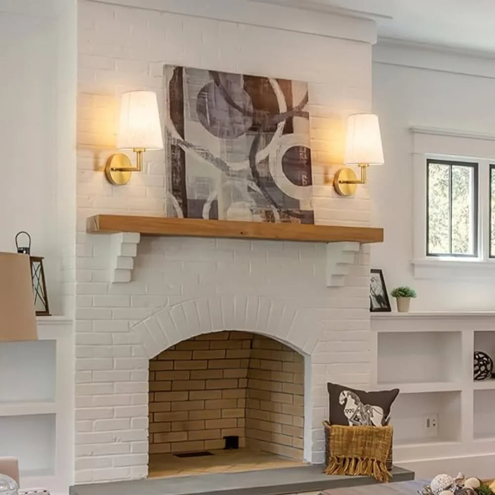 Wireless fabric wall sconce with metal accents, mounted on a wall, for renters