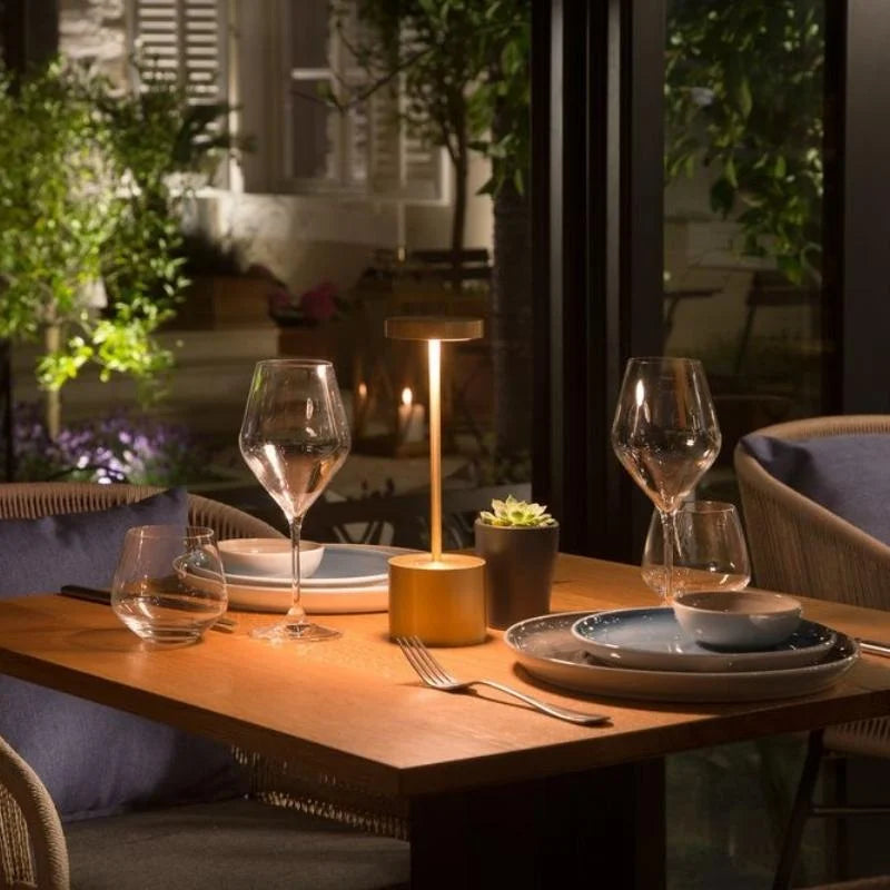Cordless table lamp with warm light on an outdoor dining table