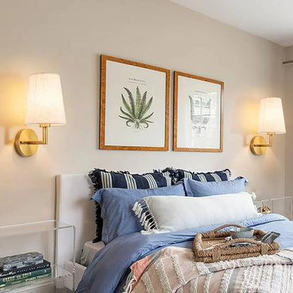 Wireless fabric wall sconce with metal accents, mounted on a wall, for renters