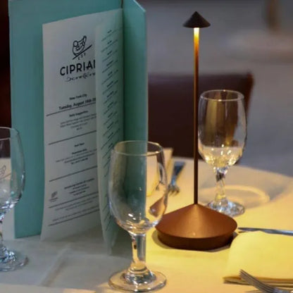 Cordless LED table lamp on a patio table for outdoor ambiance