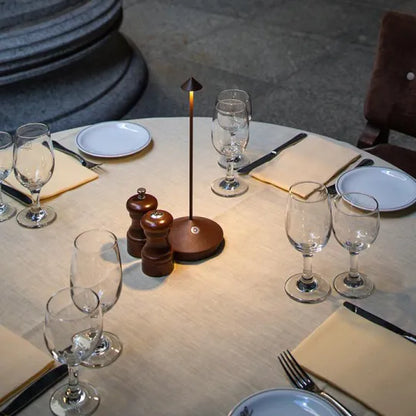 Cordless LED table lamp on a patio table for outdoor ambiance