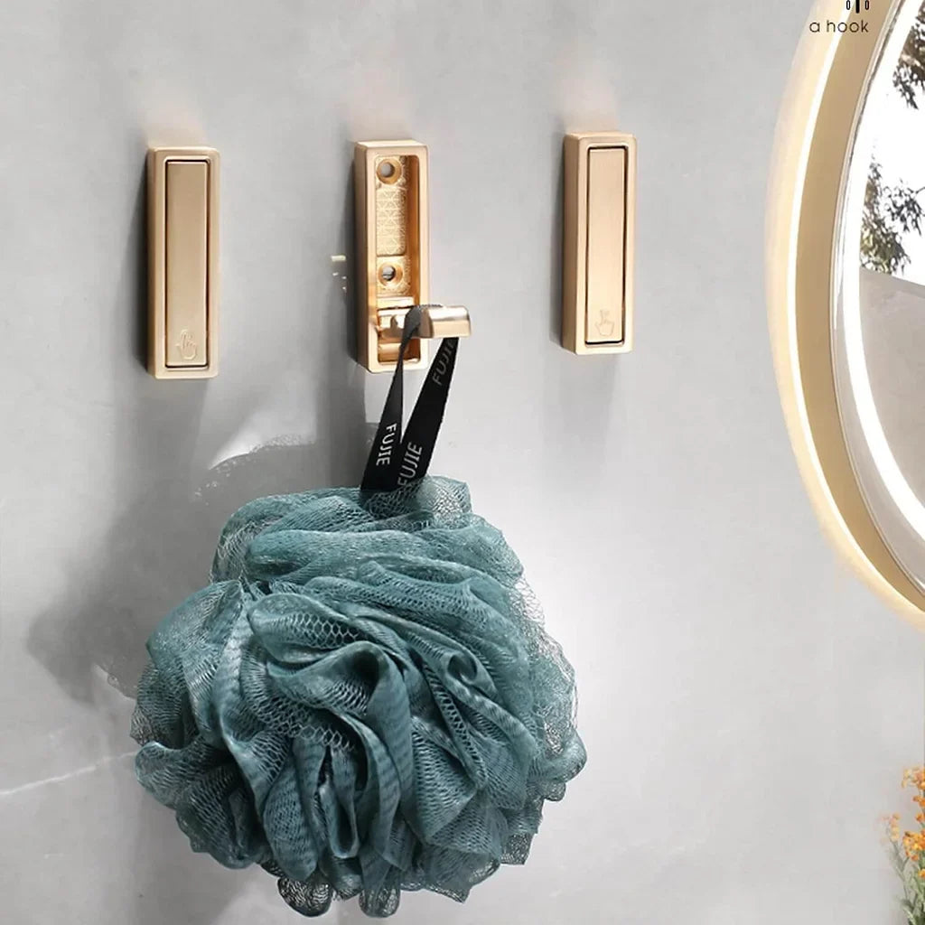 Folding coat hook folded flat against wall in small space