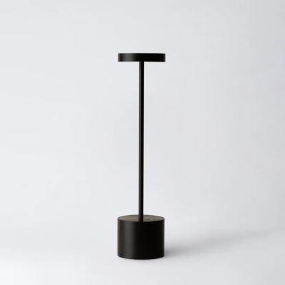 Cordless table lamp with warm light on an outdoor dining table