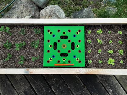 Square foot garden seed spacing template on a raised bed for beginners