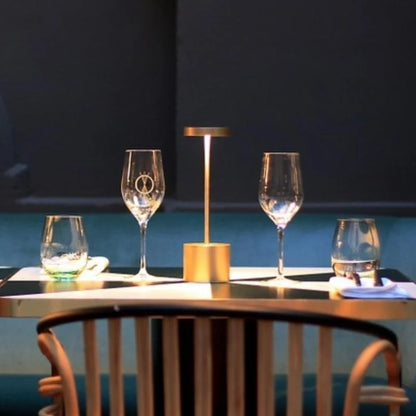 Cordless table lamp with warm light on an outdoor dining table