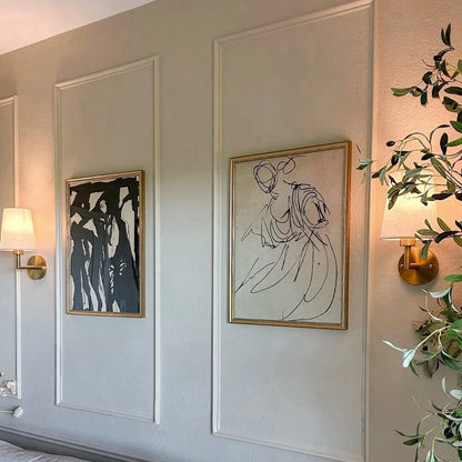 Wireless fabric wall sconce with metal accents, mounted on a wall, for renters