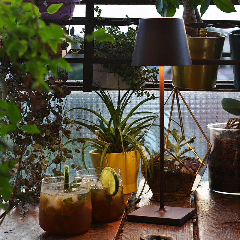 Cordless waterproof table lamp on an outdoor dining table for patio use