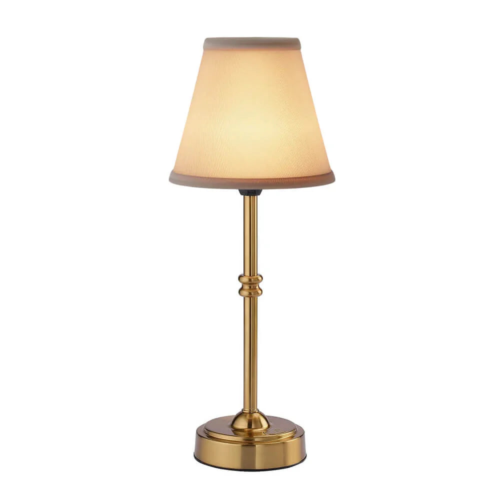 Cordless LED table lamp with fabric shade on a shelf in an apartment
