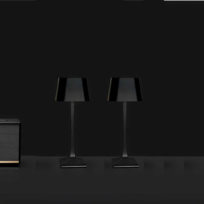 Cordless table lamp with touch controls on a bedside table, portable for any room