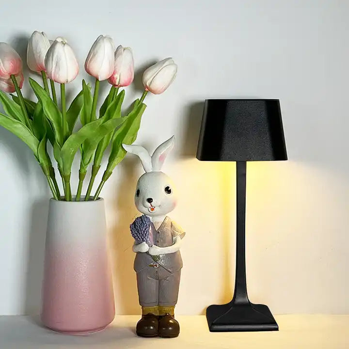 Cordless table lamp with touch controls on a bedside table, portable for any room