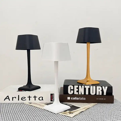 Cordless table lamp with touch controls on a bedside table, portable for any room