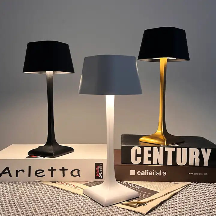 Cordless table lamp with touch controls on a bedside table, portable for any room
