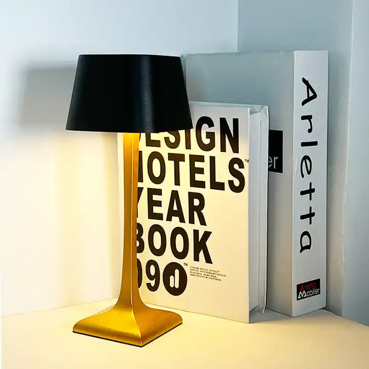 Cordless table lamp with touch controls on a bedside table, portable for any room