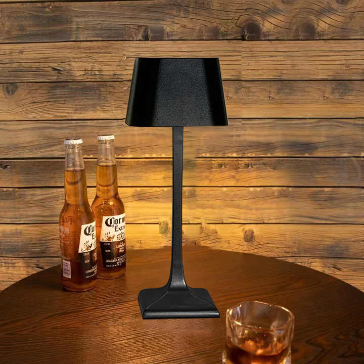Cordless table lamp with touch controls on a bedside table, portable for any room