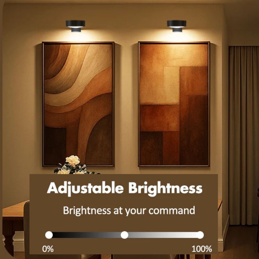 Wireless rechargeable picture light illuminating a framed photo on a wall