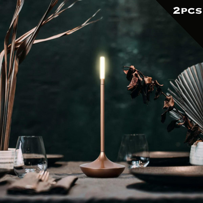 Rechargeable portable LED candle lamp with warm amber glow on a table, suitable for indoor and outdoor ambiance