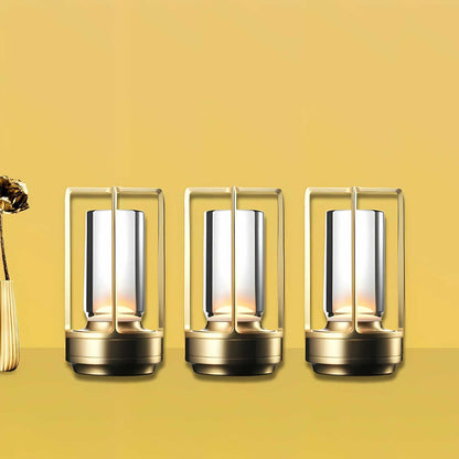 Cordless table lamp with metal cage and warm glow on a camping table
