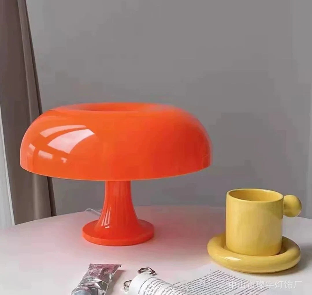 Mushroom-shaped acrylic table lamp with a warm glow on a bedside table
