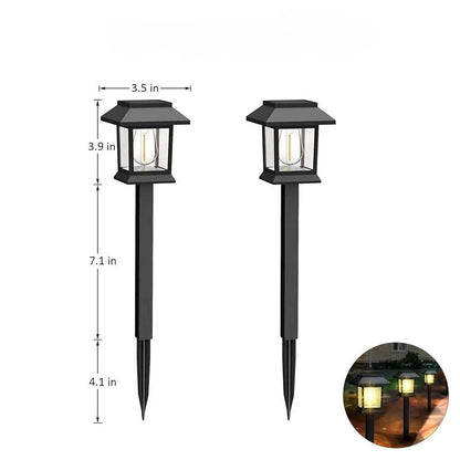 Edison-style solar lawn lights glowing along a garden path at dusk
