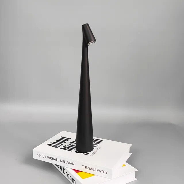 Cordless reading lamp with downward shade on a nightstand, ideal for apartment dwellers and students