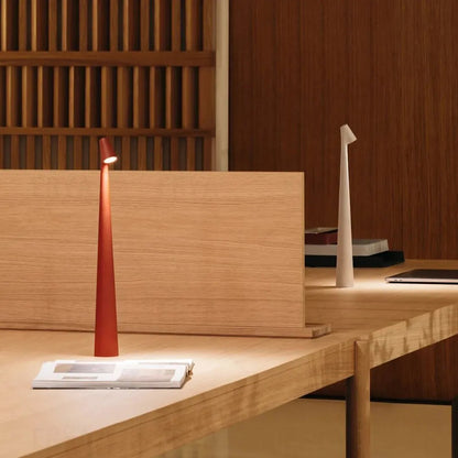 Cordless reading lamp with downward shade on a nightstand, ideal for apartment dwellers and students