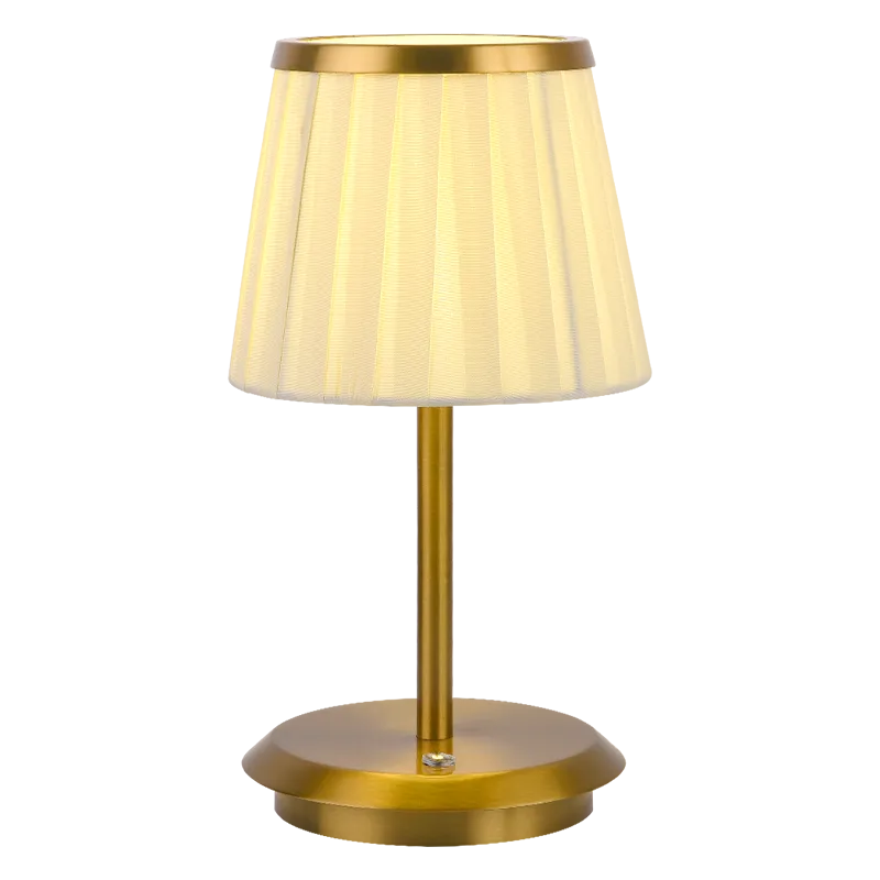 Cordless rechargeable table lamp with gold frame and fabric shade on a desk