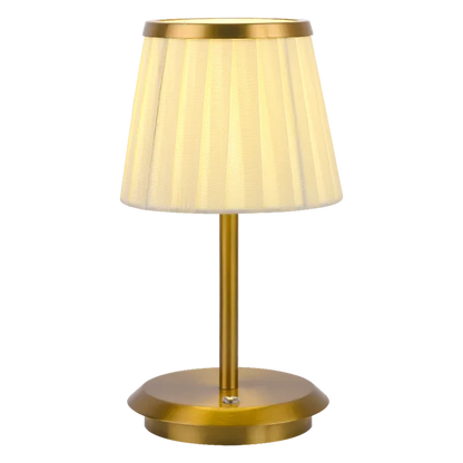 Cordless rechargeable table lamp with gold frame and fabric shade on a desk