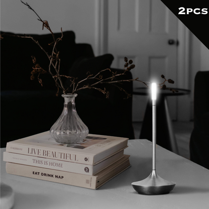 Rechargeable portable LED candle lamp with warm amber glow on a table, suitable for indoor and outdoor ambiance