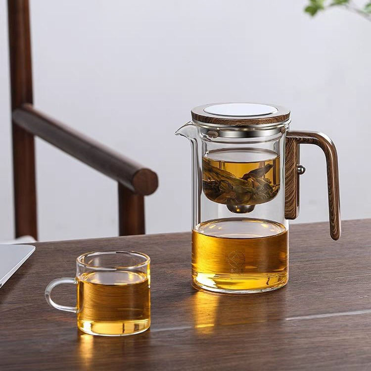 Glass teapot with one-press straining mechanism for loose-leaf tea