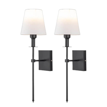Rechargeable wireless wall light with metal accents, mounted on a wall in a living room, for renters
