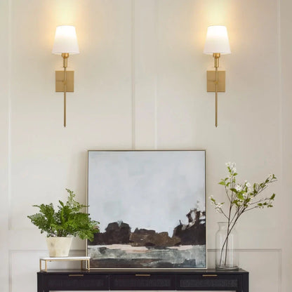 Rechargeable wireless wall light with metal accents, mounted on a wall in a living room, for renters