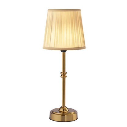 Cordless LED table lamp with fabric shade on a shelf in an apartment
