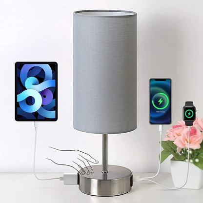 Touch table lamp with USB charging ports and AC outlet on a bedroom nightstand