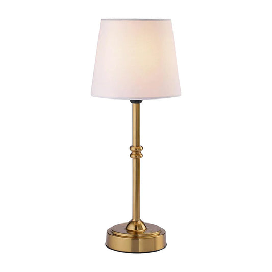 Cordless LED table lamp with fabric shade on a shelf in an apartment