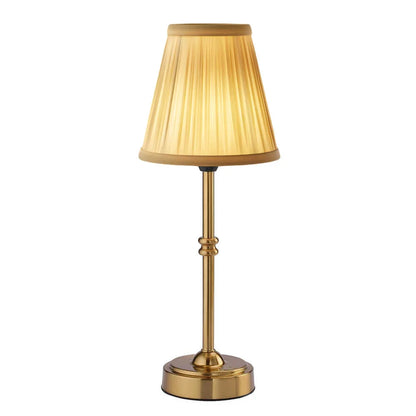 Cordless LED table lamp with fabric shade on a shelf in an apartment