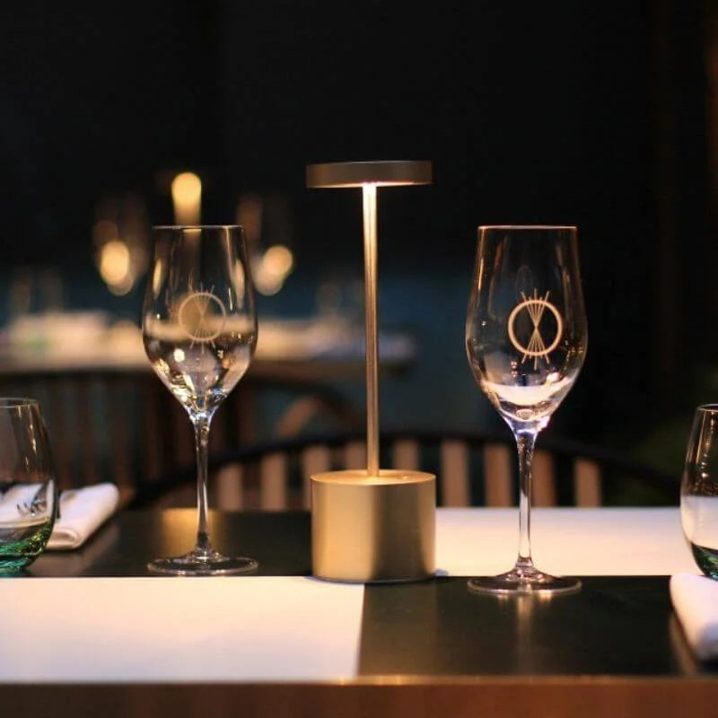 Cordless table lamp with warm light on an outdoor dining table