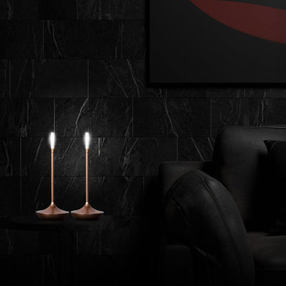 Rechargeable portable LED candle lamp with warm amber glow on a table, suitable for indoor and outdoor ambiance