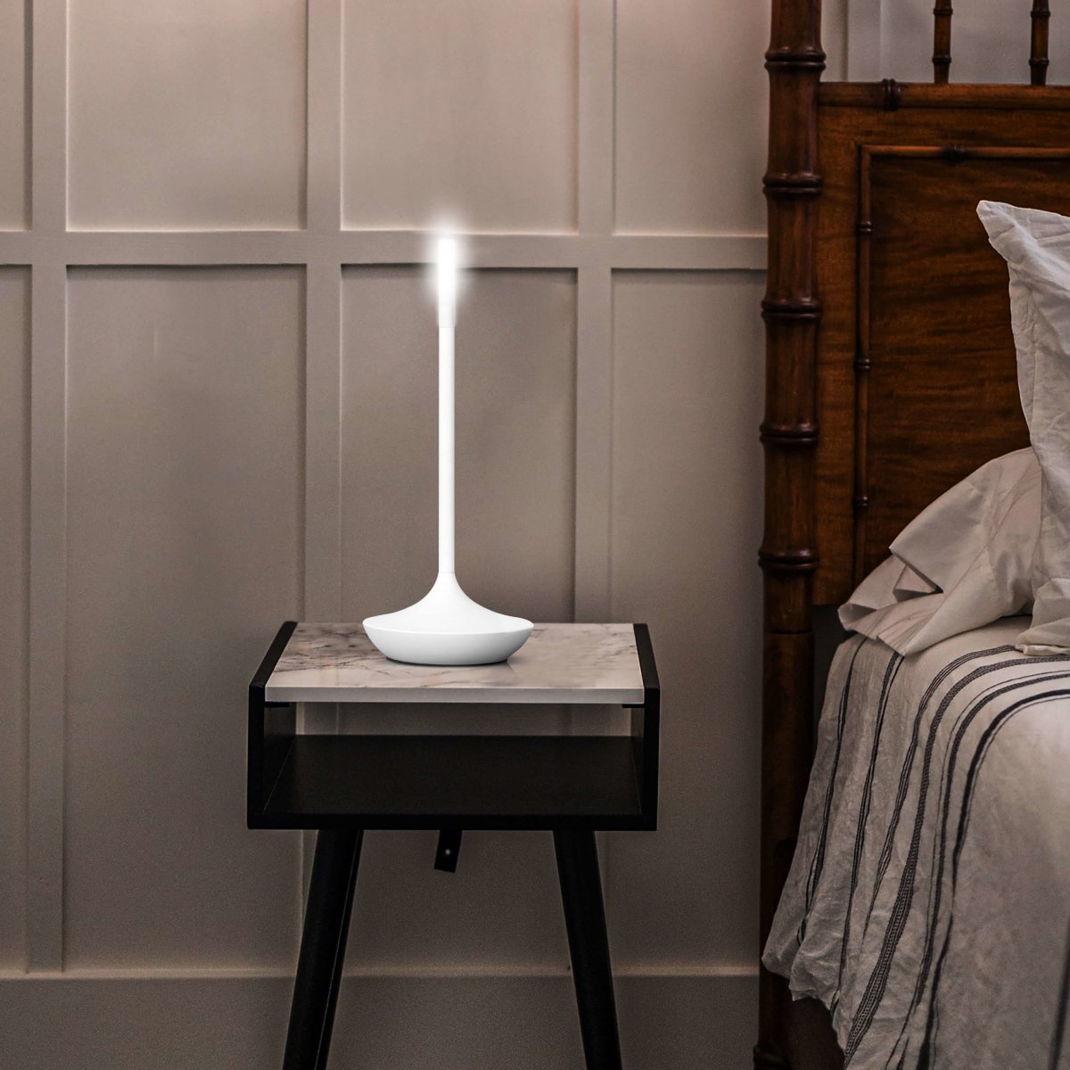Rechargeable portable LED candle lamp with warm amber glow on a table, suitable for indoor and outdoor ambiance