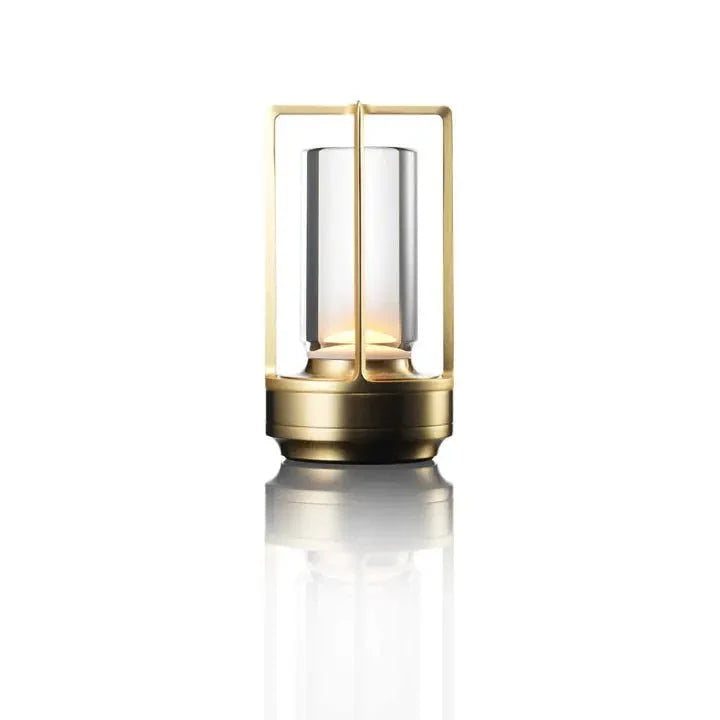 Cordless table lamp with metal cage and warm glow on a camping table